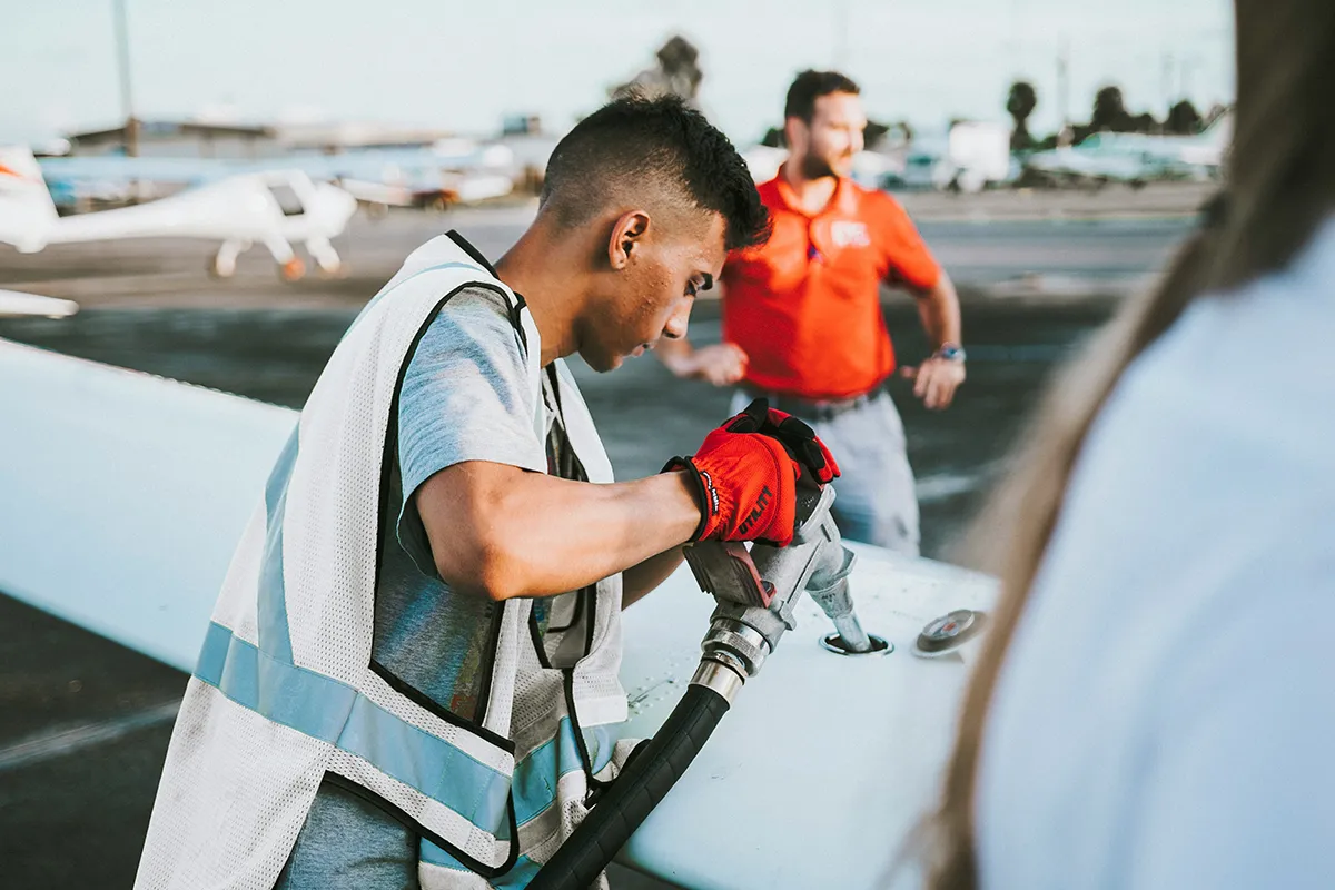 young man refueling small jet